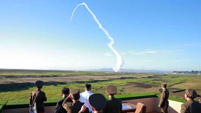 This undated picture released from North Korea's official Korean Central News Agency (KCNA) on May 28, 2017 shows North Korean leader Kim Jong-Un (C-in white shirt) watching the test of a new anti-aircraft guided weapon system organized by the Academy of National Defence Science at an undisclosed location. North Korean leader Kim Jong-Un has overseen a test of a new anti-aircraft weapon system, state media said on May 28, amid mounting tensions in the region following a series of missile tests by 