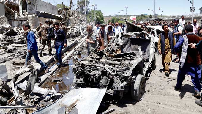 People survey the the scene of a suicide bomb attack in Kabul, Afghanistan, 31 May 2017.