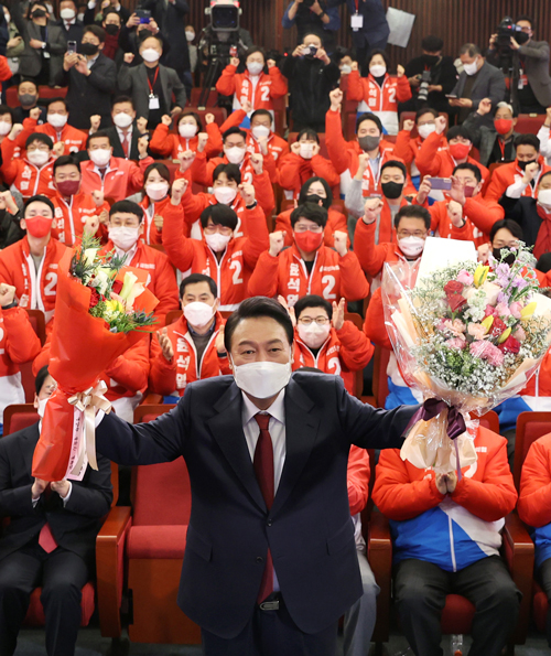 Yoon Suk‑yeol of the main opposition People Power Party poses with bouquets after he was elected President over Lee Jae‑myung of the ruling Democratic Party at the National Assembly in Seoul, South Korea, 10 March 2022. EPA/YONHAP　SOUTH KOREA OUT　EPA＝時事　写真提供：時事通信社