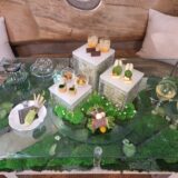 世界農業遺産の伝統的栽培方法「畳石式」をモチーフにしたスタンドと、わさびの花や苔を表現したテーブル